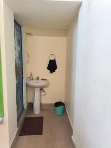 a bathroom with a white sink and a sink at Cozy Homestay AC 400 per day in Guwahati