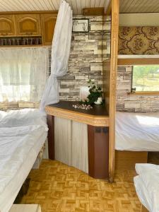 a bedroom with two beds and a desk in a room at Beachfront Caravans - Meadow Camp in Chernomorets