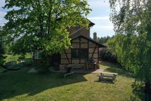 a log cabin with a picnic table and benches in the yard at Landbahnhof Buschhof 1 Stock in Buschhof +20 photos