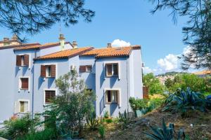 a white building with a red roof at CroLos2 in Mali Lošinj