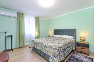 a bedroom with a bed and a large window at CroLos2 in Mali Lošinj