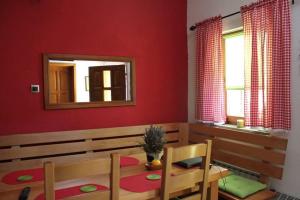 a dining room with a table and a mirror at Apartman Maja in Gračac