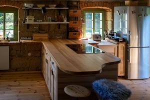 a kitchen with a large island in the middle at ENJOY Cozy Romance Hills Forest Gardens Views Sauna Whirlpool Bath in Jablonné v Podještědí