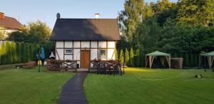 a small house in the middle of a yard at Chata nad Rzeką in Lipusz