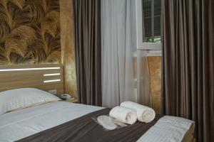 a hotel room with a bed with towels on it at Opera Avenue Hotel in Yerevan