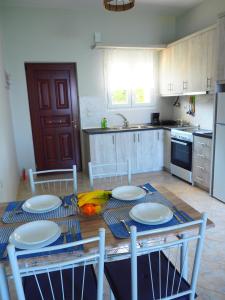 a kitchen with a table with plates on it at TSOUMAS HOUSE 1 in Preveza