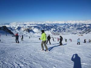 a group of people skiing on a snow covered mountain at 9 persons apartment Haus Anna Louise in Niedernsill