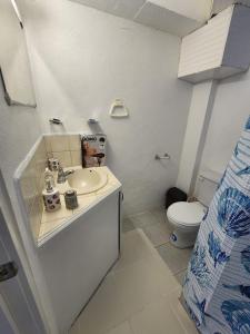 a bathroom with a sink and a toilet at Chez Emmanuel in Gros Islet