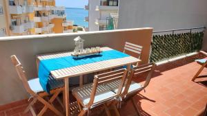 a table and chairs on a balcony with the ocean at Cantinho do Sol - Sea view, Quiet, Cozy and Relaxing Flat in Armação de Pêra