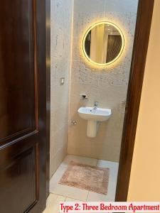 uma casa de banho com um lavatório e um espelho em Luxury Apartments Beside Mall of Arabia and Dar Al-Fouad hospital - Families only- No Alcoholic Beverages em Cidade 6 de Outubro