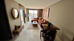 a living room with a couch and a table at Cozy flat - Casa port & Sea view in Casablanca