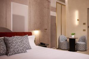 Postel nebo postele na pokoji v ubytování Borghese Contemporary Hotel