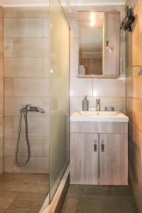 a bathroom with a shower and a sink at Stone house with Amazing View in Kótronas
