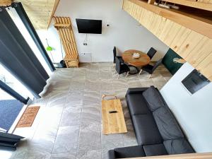 an overhead view of a living room with a couch and a table at A Frame Chalet By Superski in Cavnic