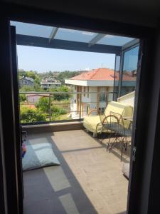 a view from the door of a balcony with a view of a house at Özel Villa in Sarıyer