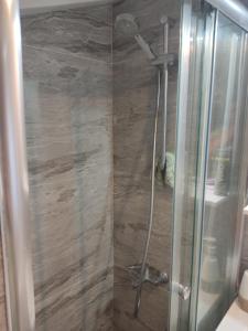 a bathroom with a shower with a glass door at Özel Villa in Sarıyer