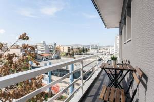 a balcony with a table and a view of a city at Apartment in Keramikos, Athens in Athens