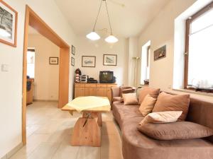 a living room with a couch and a table at Beautiful Apartment in Rerik with Garden near Sea in Rerik