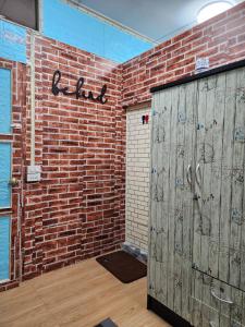 a room with a brick wall and a garage at 206 Quiet and Cozy Apartment in Bangkok