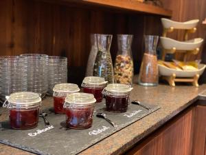 a group of jars of jam sitting on a counter at Hotel Starchlhof in Schladming