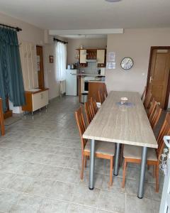 - une salle à manger et une cuisine avec une table et des chaises dans l'établissement Erdőgyöngye Vendégház CSÖDE, à Csöde