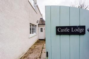 a sign on the side of a building with a castle lodge at Castle Lodge in Pembrokeshire