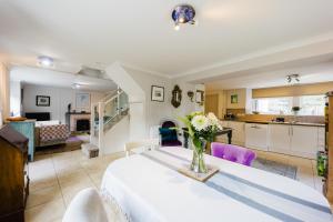 a room with a table with a vase of flowers on it at Castle Lodge in Pembrokeshire