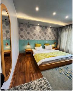 a bedroom with a large bed and a mirror at Maple house ladakh in Leh