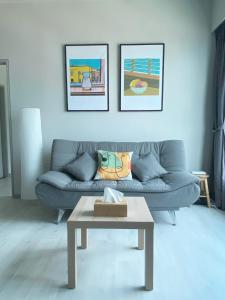 a living room with a couch and a coffee table at Jesselton Quay by Bunga Raya Homes in Kota Kinabalu