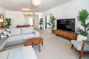 a living room with a couch and a flat screen tv at LME101A- Lovley Apartment with stunning views in Estepona