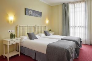 Un pat sau paturi într-o cameră la IRAIPE Ongi Hotel