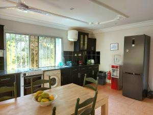 A kitchen or kitchenette at Bougainvillea House