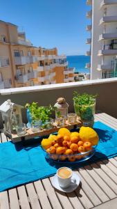 a plate of fruit on a table on a balcony at Cantinho do Sol - Sea view, Quiet, Cozy and Relaxing Flat in Armação de Pêra