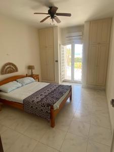 a bedroom with a bed and a ceiling fan at Chalet Marina Alamein first row sea view 3 bedroom-North Coast in El Alamein