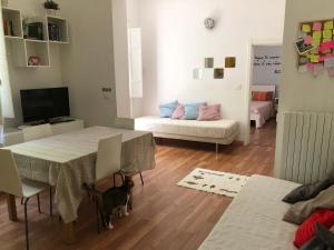 a living room with a table and a couch at Villa Viola in Forlì