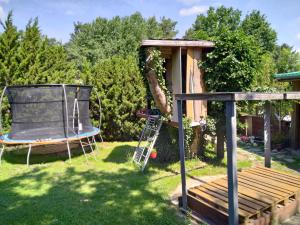 a backyard with a swing and a gazebo at Ferienhaus Feuer Wasser Luft Erde in Dobbrikow