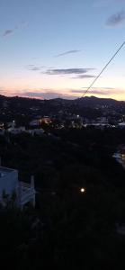 a view of a city at sunset with a street light at Panorama Appartment in Agia Marina