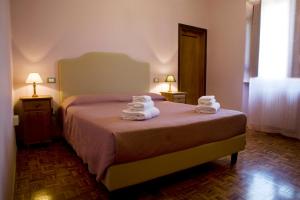 a bedroom with a bed with towels on it at Casale Dell'Orso in Pistoia +33 photos