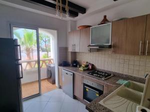 a kitchen with a sink and a stove top oven at Appartement pieds dans l’eau à sidi Rahal in Sidi Rahal