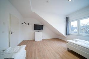 Habitación blanca con cama y TV en DQ03 - Geräumige Monteurwohnung Koblenz en Koblenz