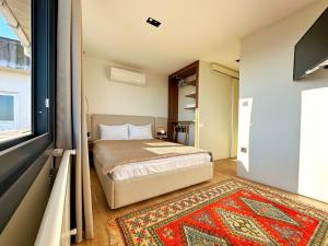 a bedroom with a bed and a television and a rug at Sultan Pier Hotel in Istanbul