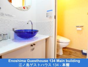 a bathroom with a blue sink and a toilet at Enoshima Guest House 134 - Vacation STAY 12964v in Fujisawa