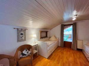 a room with a bed and a couch and a window at Ferienhaus Sissi in Schwangau