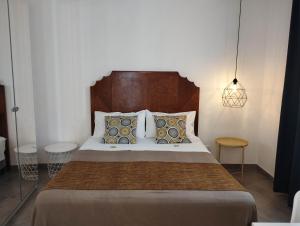 a bedroom with a large bed with pillows at Anita & Garibaldi in Marsala
