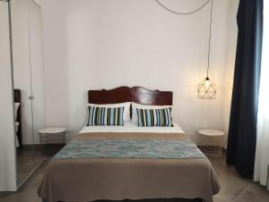a bedroom with a large bed with two pillows at Anita & Garibaldi in Marsala