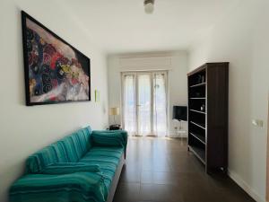 a living room with a couch and a painting on the wall at YourHome - Villa Sorrento in Meta