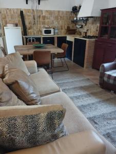 a living room with a couch and a table at Hideaway @ The Orchard in Alcudia de Monteagud