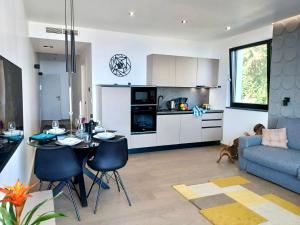 a kitchen and living room with a couch and a table at Aparthotel Villa V with pool and parking in Rijeka