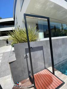 a glass door in front of a house with a pool at Villa V in Rijeka