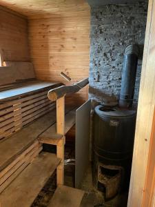 a inside of a sauna with a large stove at JUST Lodges in Orissaare